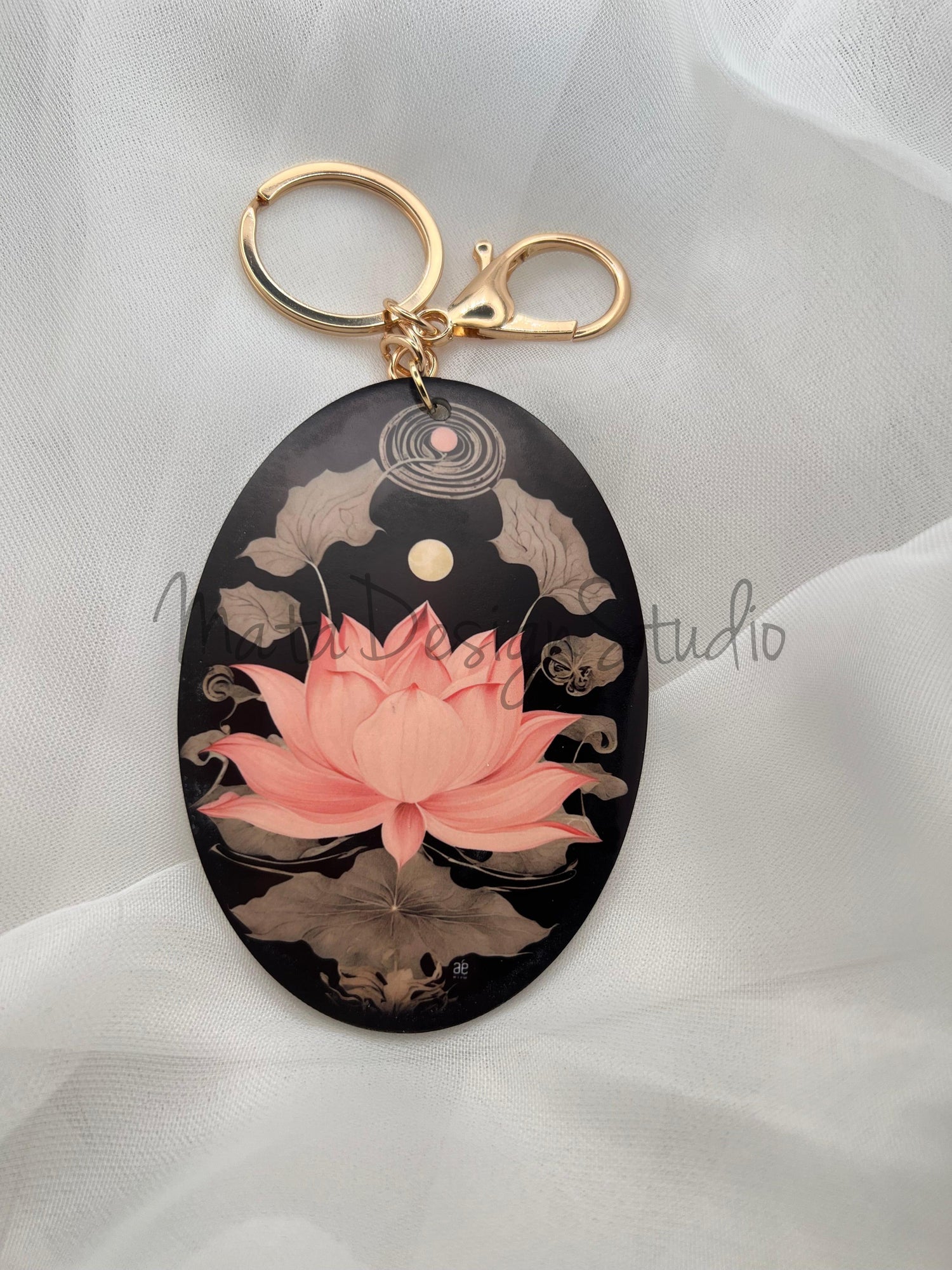 Artist-edition keychain featuring a blooming pink lotus flower on a dark artistic background, symbol of inner harmony and peace.